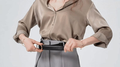 Close-up of a Solenna no-hole ratchet belt worn with a polished outfit