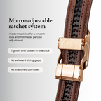 Brown micro-adjustable belt with gold buckle on a light gray background, featuring text about micro-adjustable ratchet system.